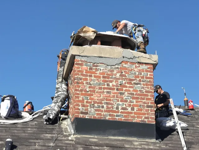 Warwick Chimney Sweep installing a custom chimney crown in Warwick, RI