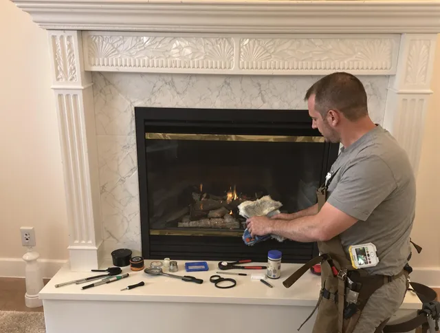 Warwick Chimney Sweep performing fireplace maintenance in Warwick, RI